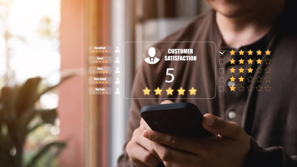 A male customer gives a five-star rating on their smartphone